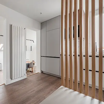 A kitchen with American White Oak Stips as a partial screen dividing the room 