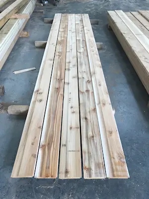 Several pieces of British Cedar Cladding laid on the floor