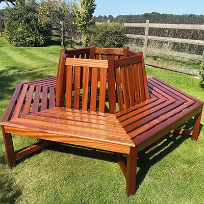 A garden bench made from Timbersource's Sapele in a freshly cut grass garden