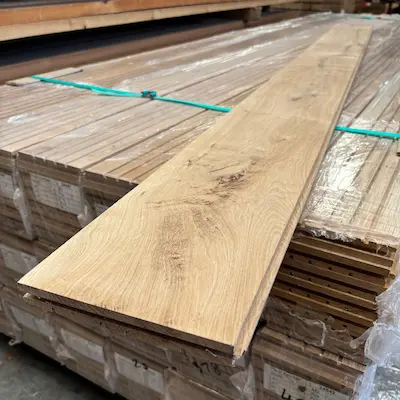A piece of Timbersource's European Oak machined to a Tongue and Groove Profile sitting on a pack of timber