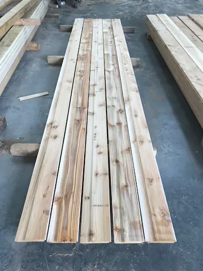 Several pieces of British Cedar Cladding laid on the floor
