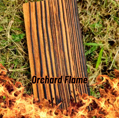 A piece of Charred (Orchard Flame) Larch sitting on some grass with flames at the bottom