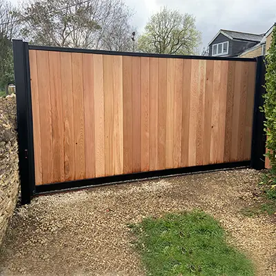 A driveway gate made with Timbersource's Canadian Western Red Cedar for the virticle cladding