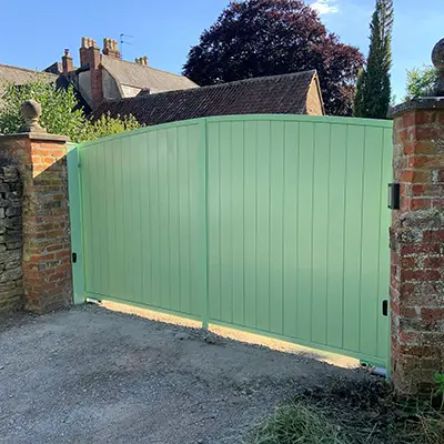 A driveway gate made with Timbersource's West African Sapele, painted green