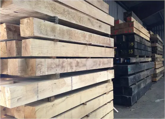 A row of stacks of Oak Beams within Timbersource's yard