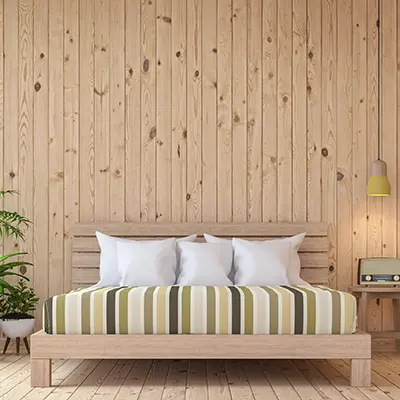 Timbersource's Scandinavian Redwood Pine Cladding on the wall of a bedroom