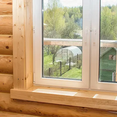 The corner of a window frame made of Pine