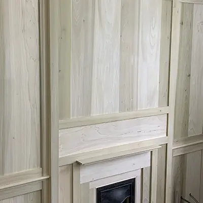 Panelling surrounding a fireplace made with Timbersource's American Poplar