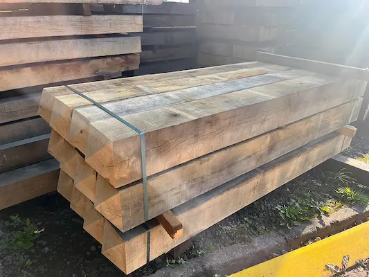 Four way weathered posts in a pack amongst other packs of Oak beams