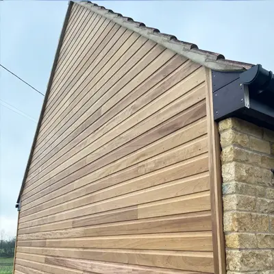 Timbersource's West African Iroko Cladding on the side of a building